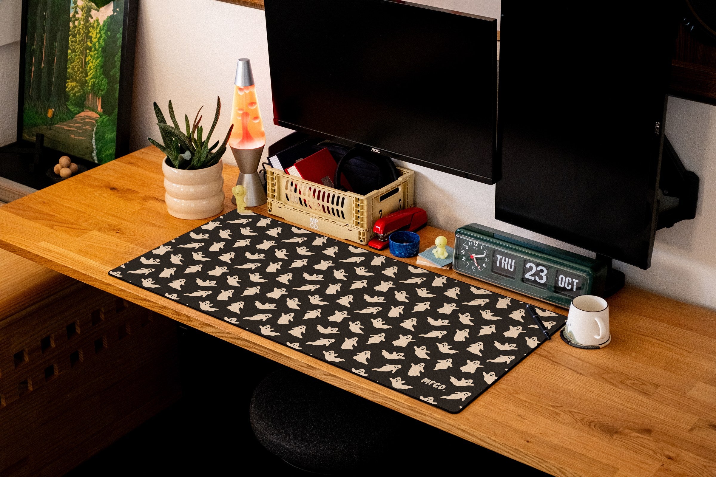 Ghosts desk mat in Black, shown on a styled desk setup