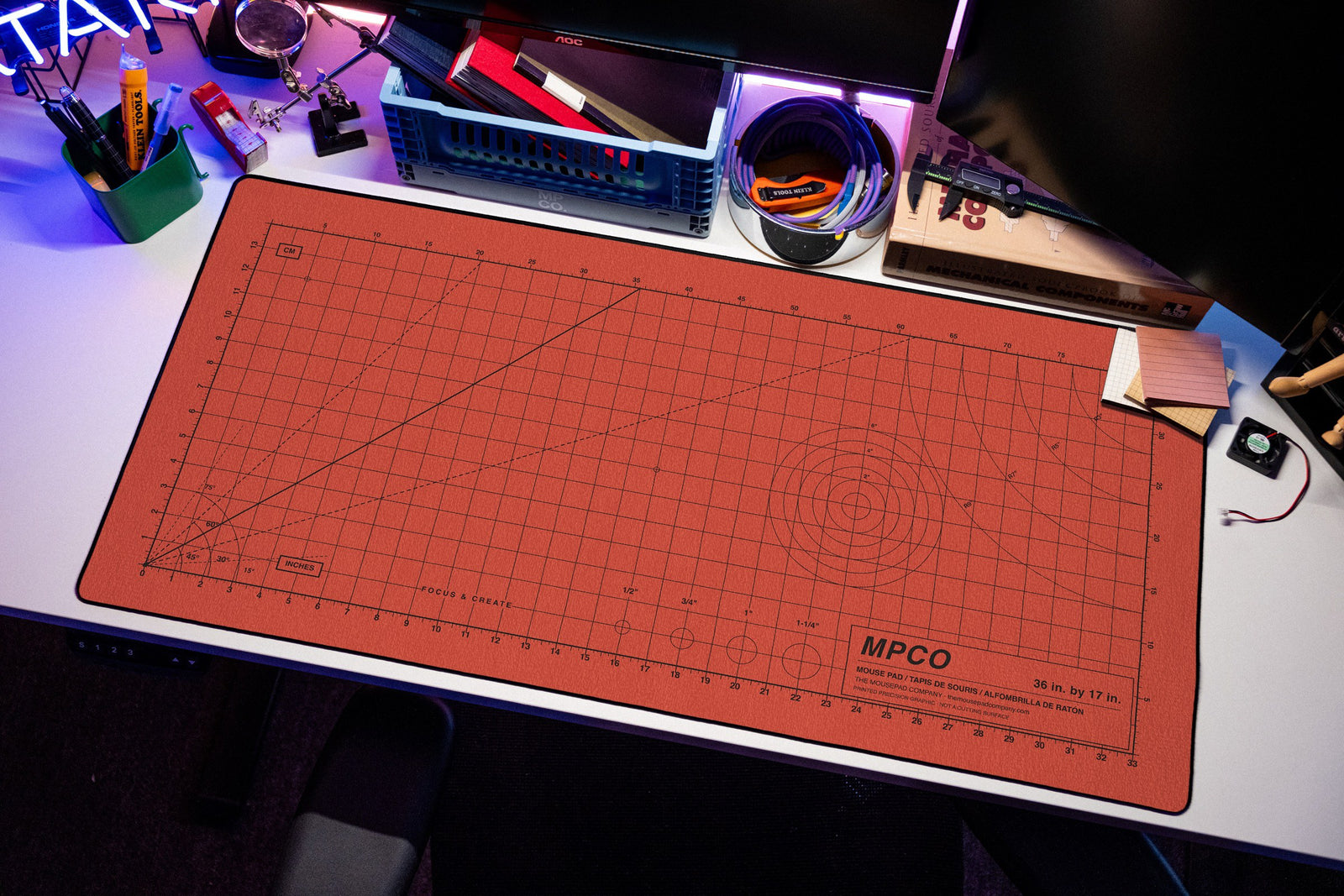 Draftpad desk mat in Red / Black, shown on a styled desk setup