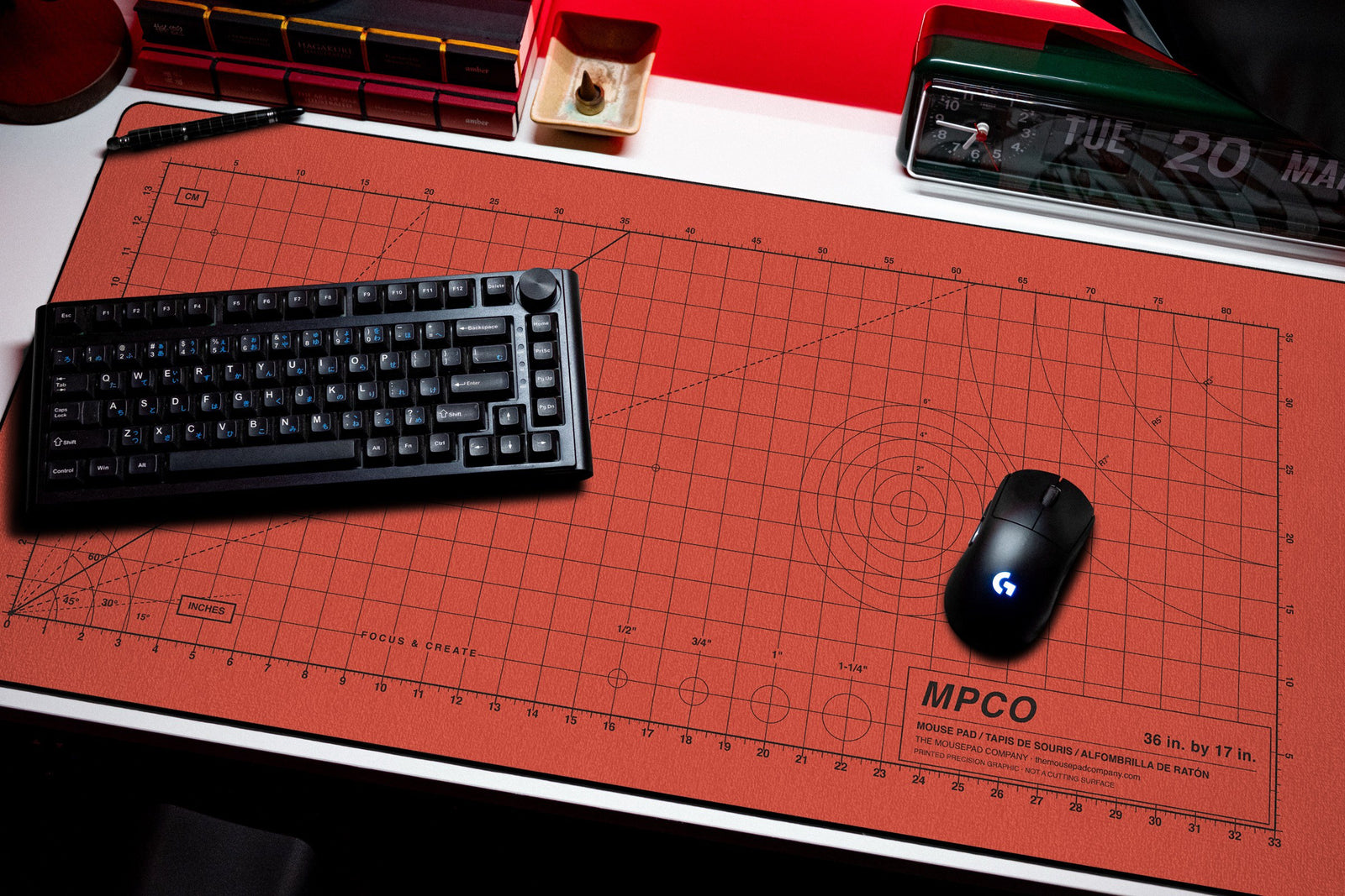 Draftpad desk mat in Red / Black, shown on a styled desk setup
