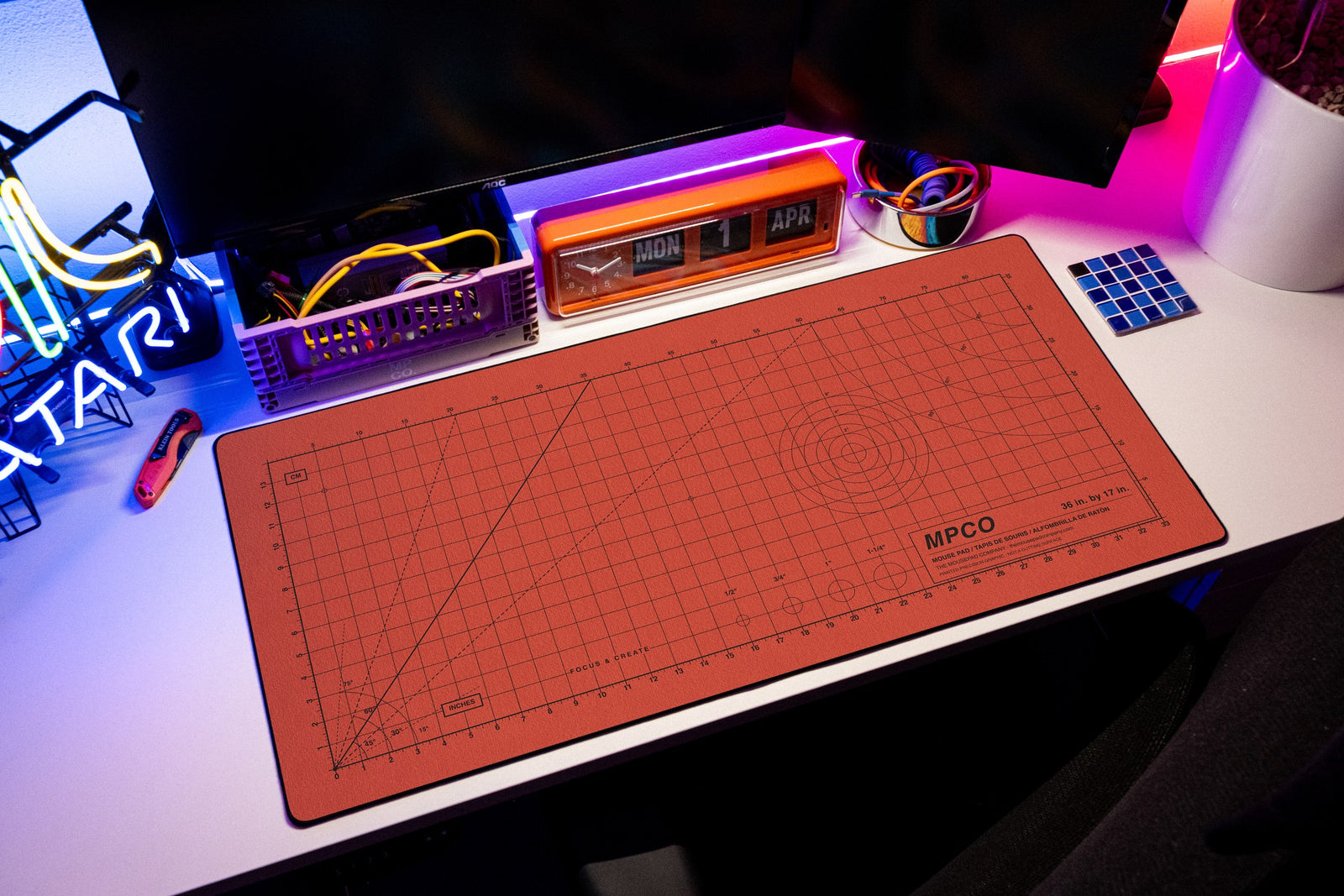 Draftpad desk mat in Red / Black, shown on a styled desk setup
