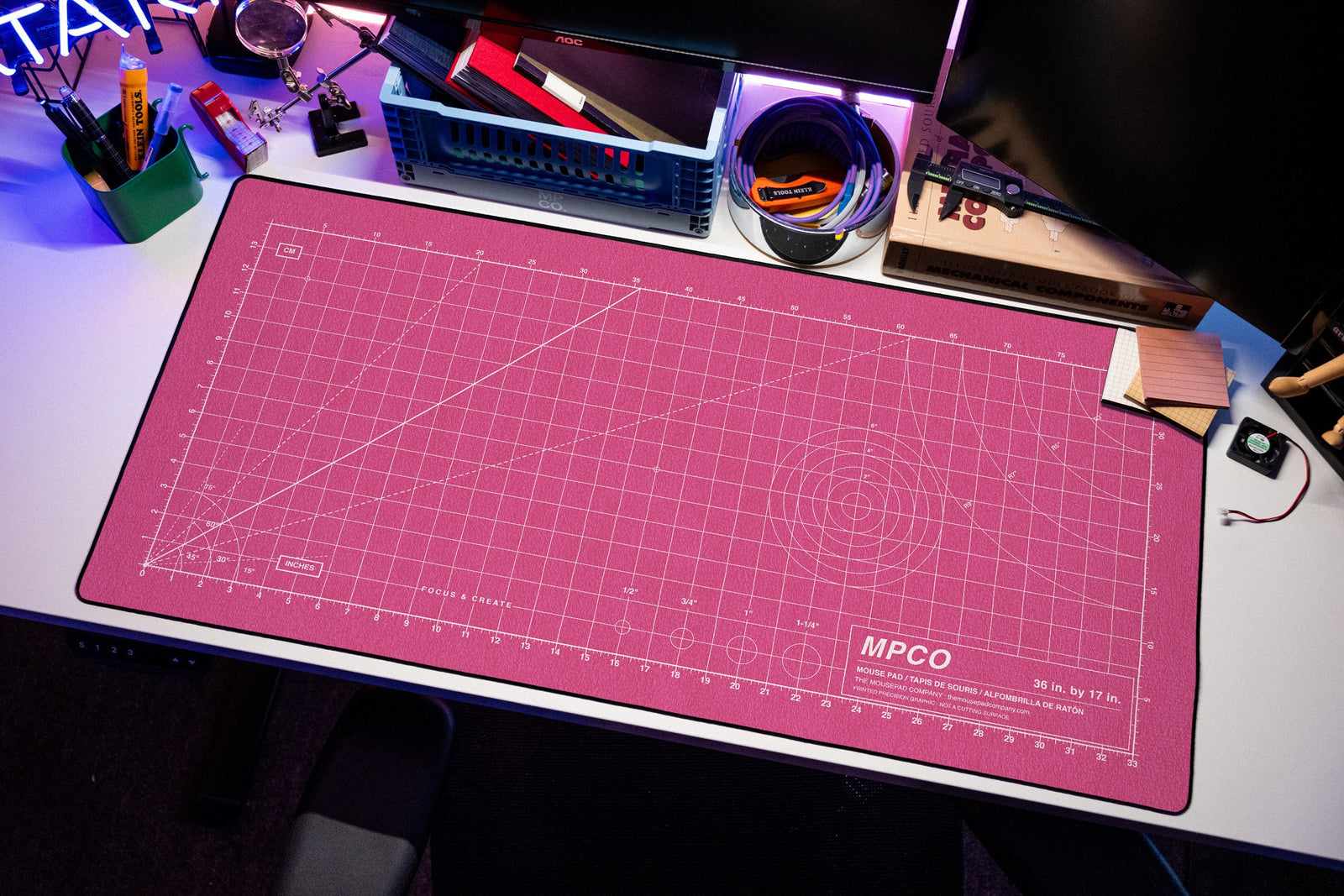Draftpad desk mat in Pink / White, shown on a styled desk setup