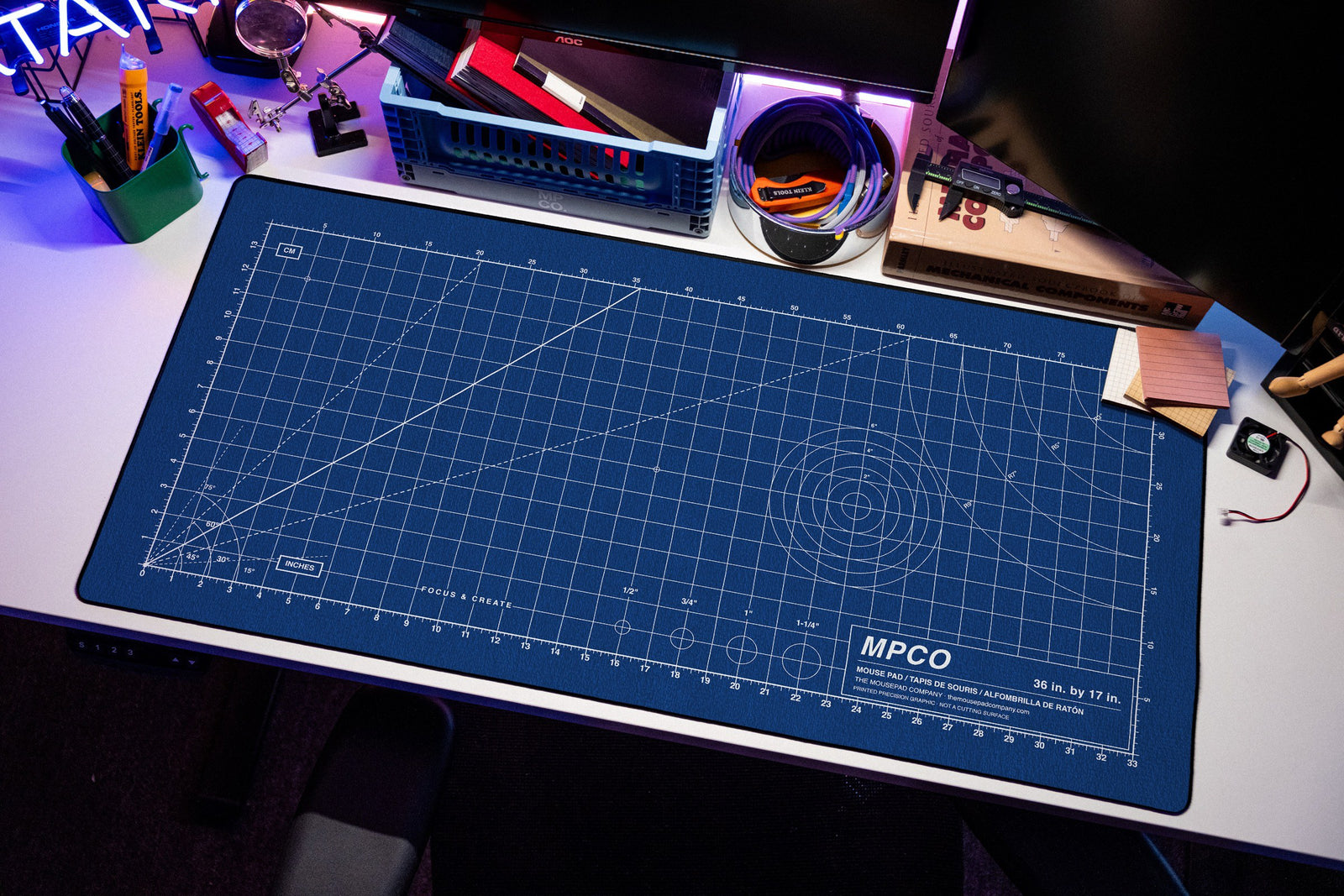 Draftpad desk mat in Blue / White, shown on a styled desk setup