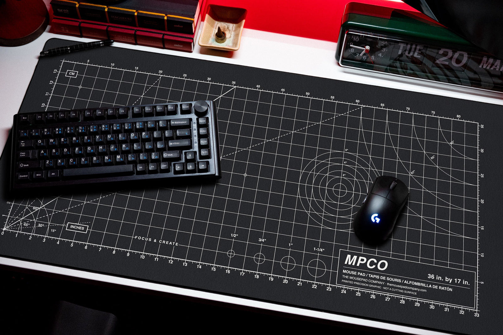 Draftpad desk mat in Black / White, shown on a styled desk setup