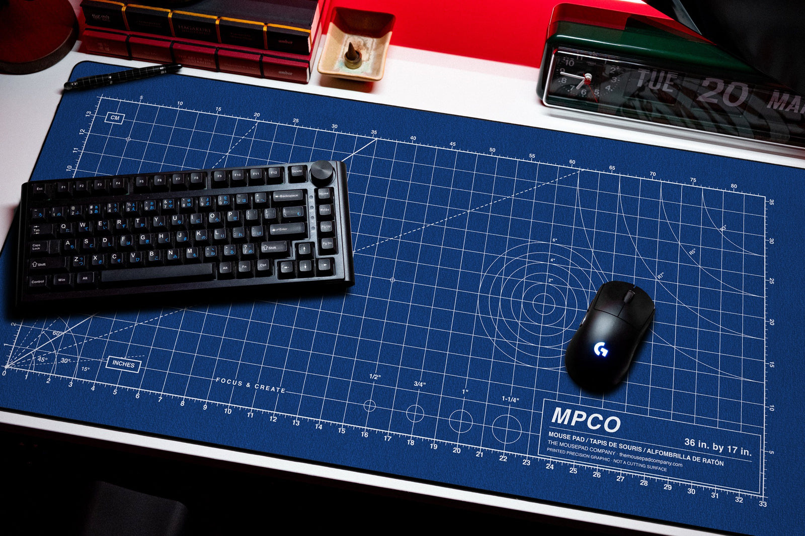 Draftpad desk mat in Blue / White, shown on a styled desk setup