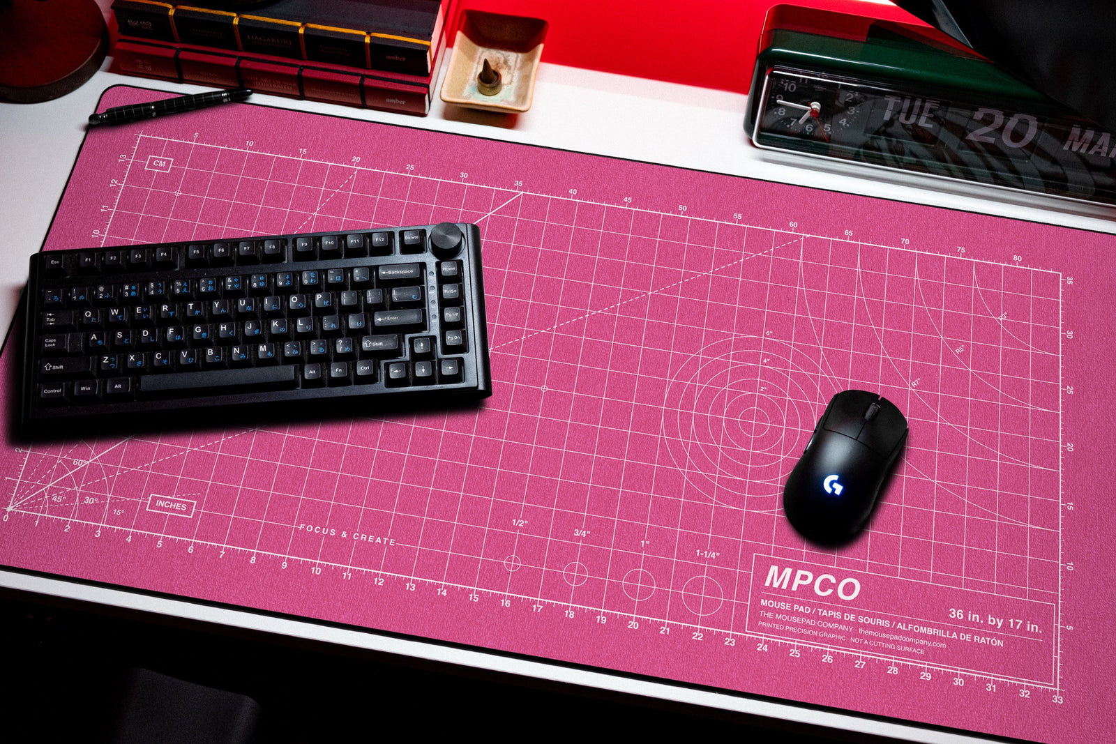 Draftpad desk mat in Pink / White, shown on a styled desk setup