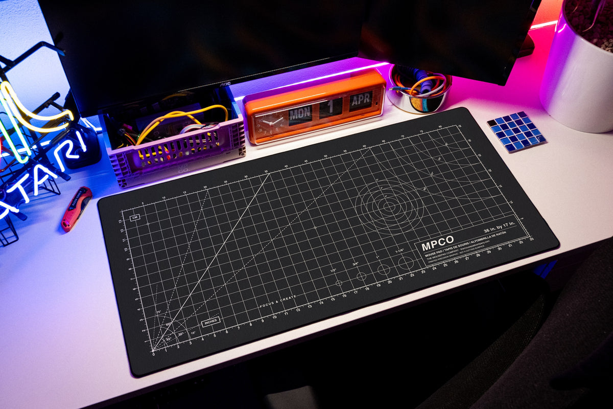 Draftpad desk mat in Black / White, shown on a styled desk setup