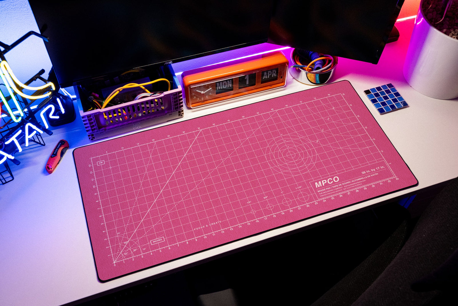 Draftpad desk mat in Pink / White, shown on a styled desk setup