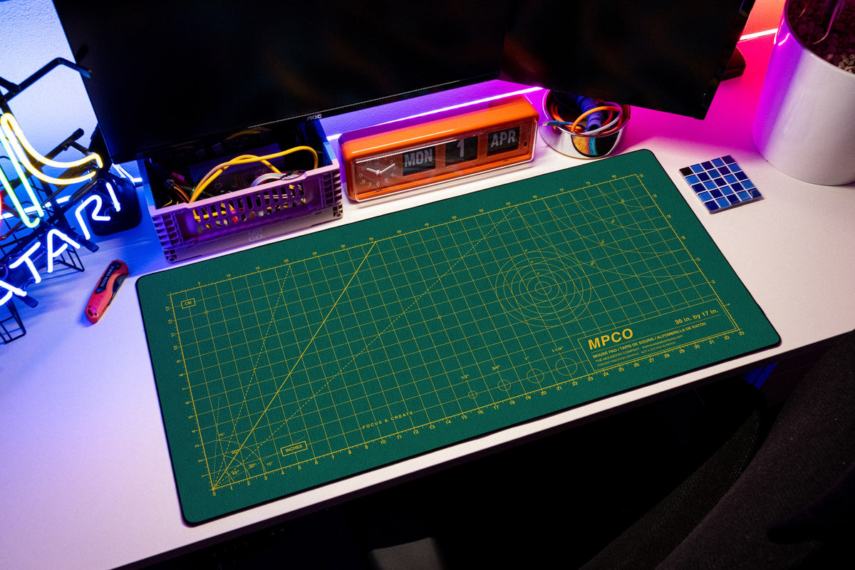 Draftpad desk mat in Green / Yellow, shown on a styled desk setup