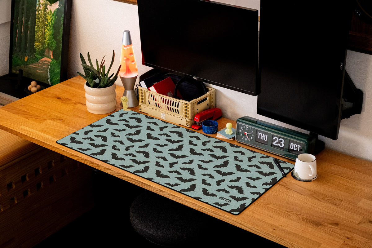 Bats desk mat in Blue, shown on a styled desk setup