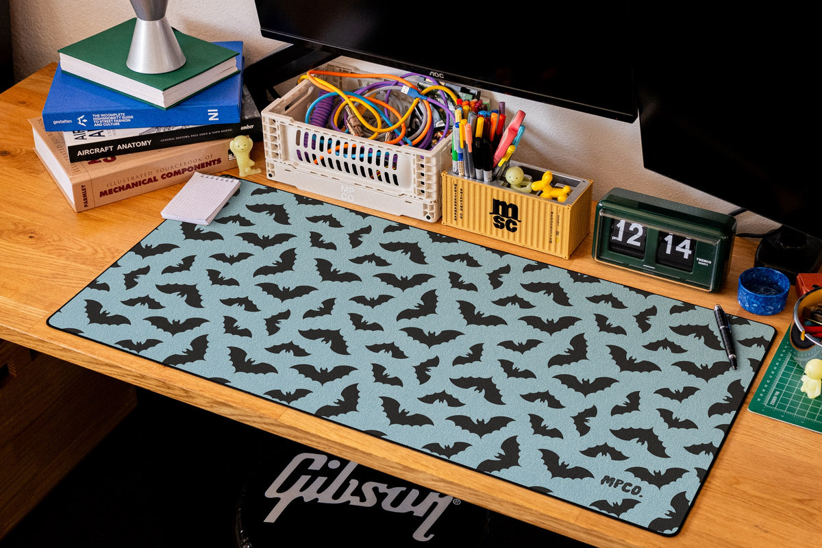 Bats desk mat in Blue, shown on a styled desk setup