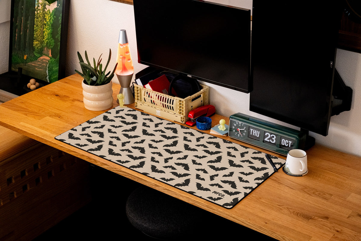 Bats desk mat in Cream, shown on a styled desk setup