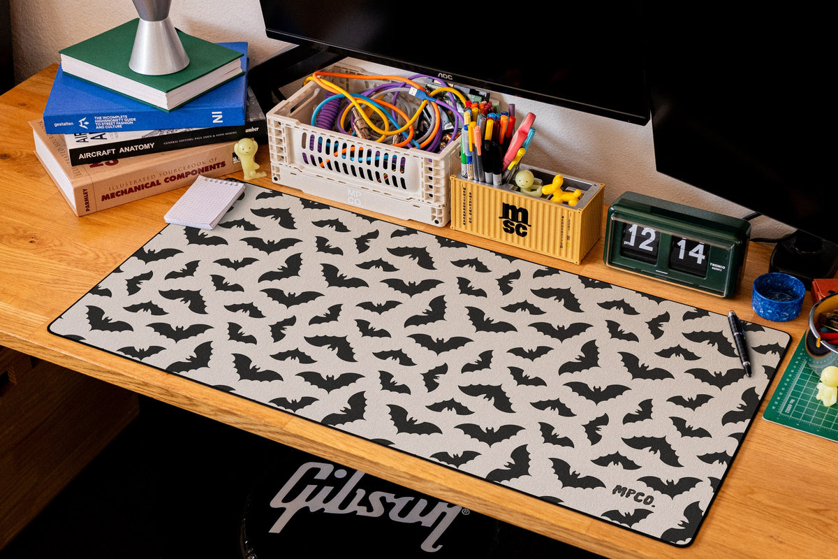 Bats desk mat in Cream, shown on a styled desk setup