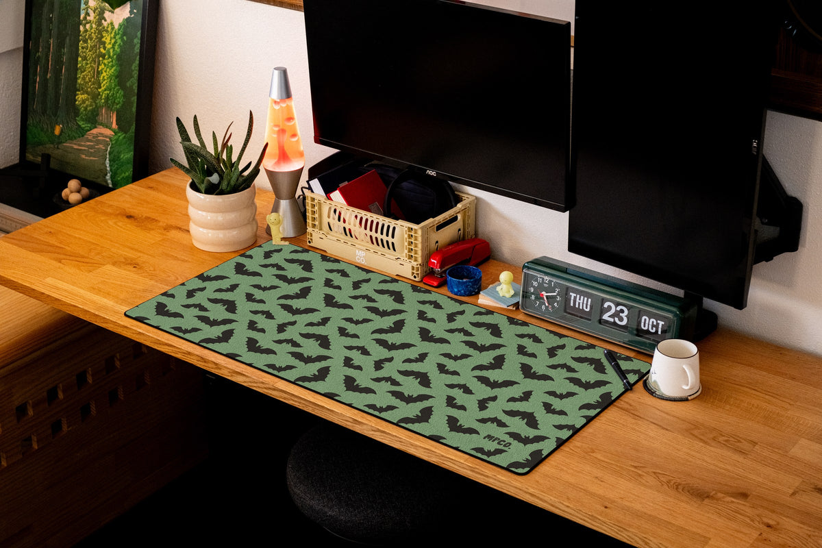 Bats desk mat in Green, shown on a styled desk setup