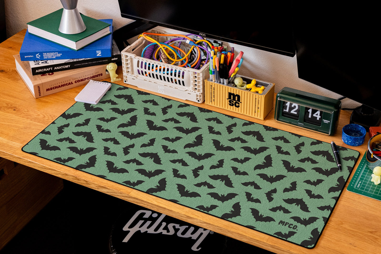 Bats desk mat in Green, shown on a styled desk setup