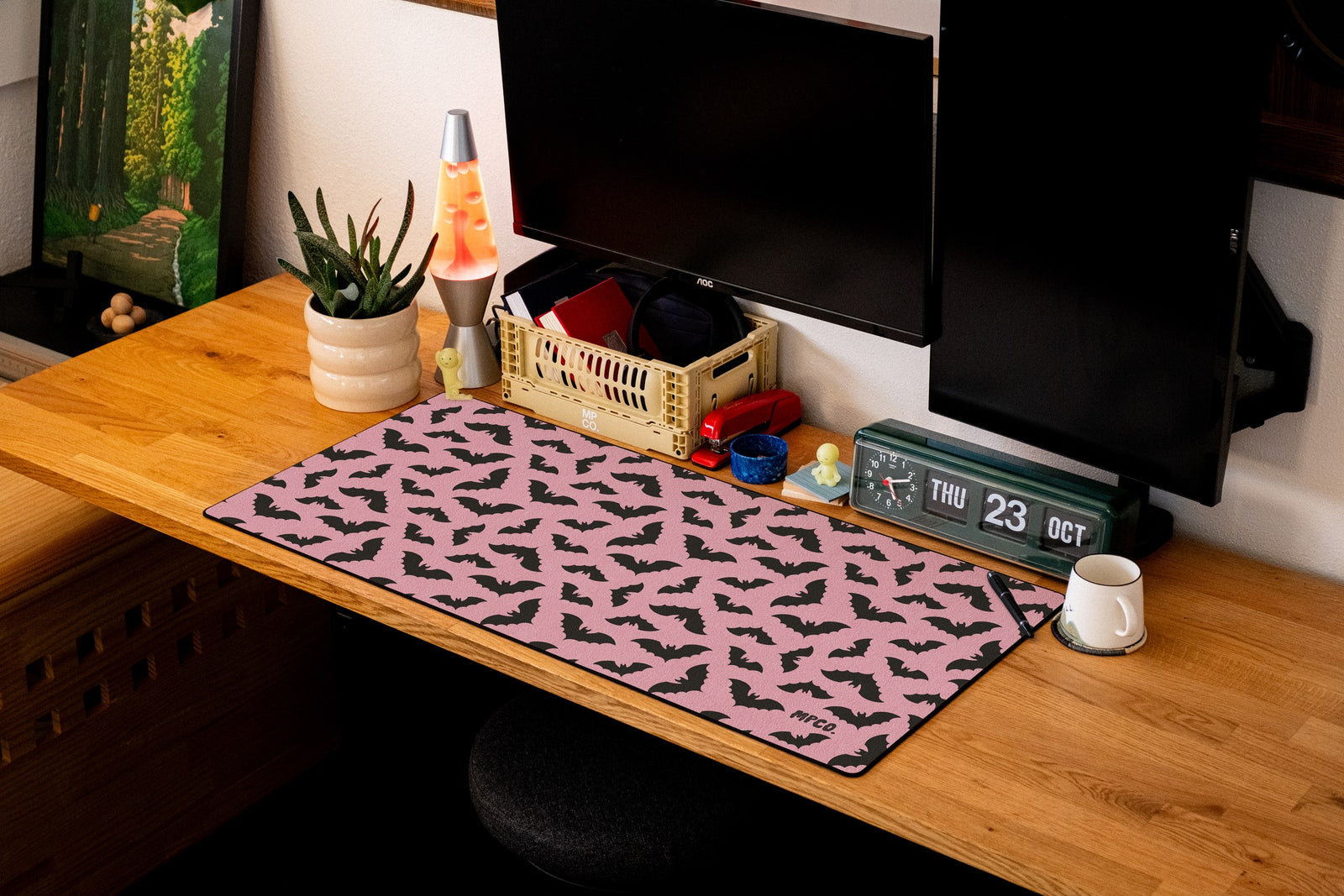 Bats desk mat in Pink, shown on a styled desk setup