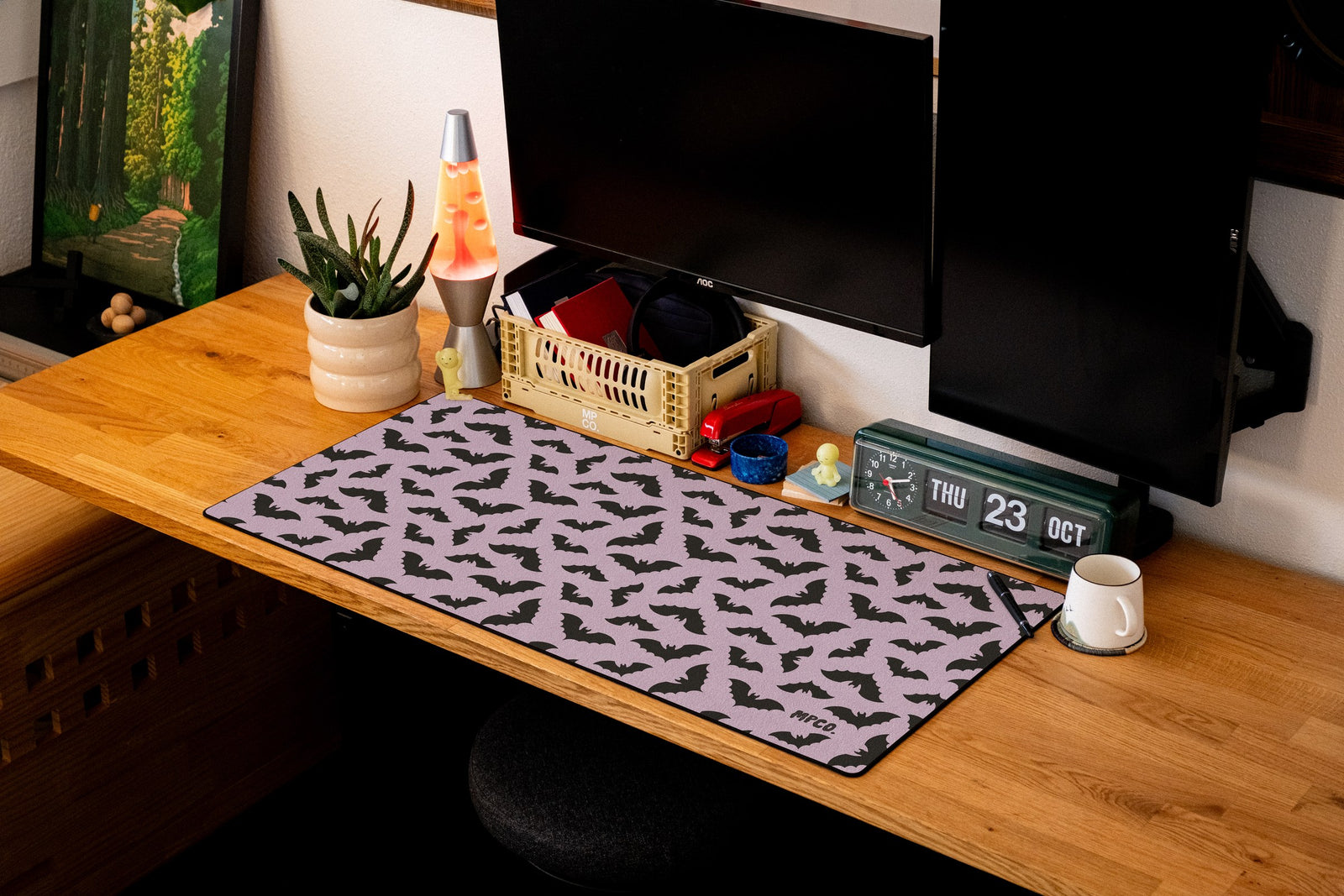 Bats desk mat in Purple, shown on a styled desk setup