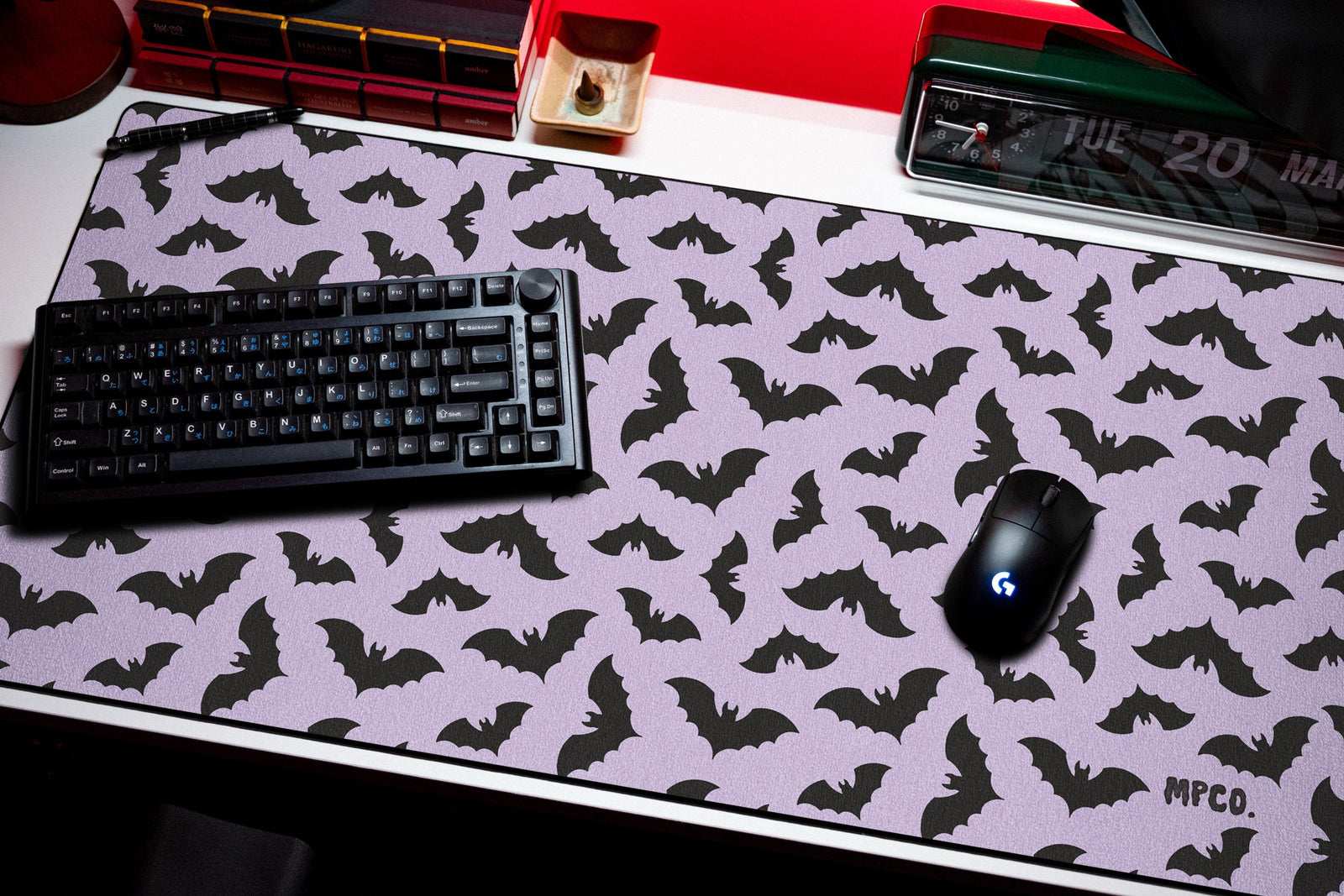 Bats desk mat in Purple, shown on a styled desk setup
