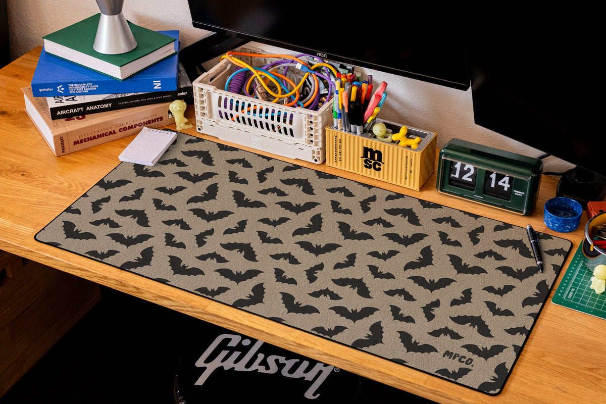 Bats desk mat in Sand, shown on a styled desk setup