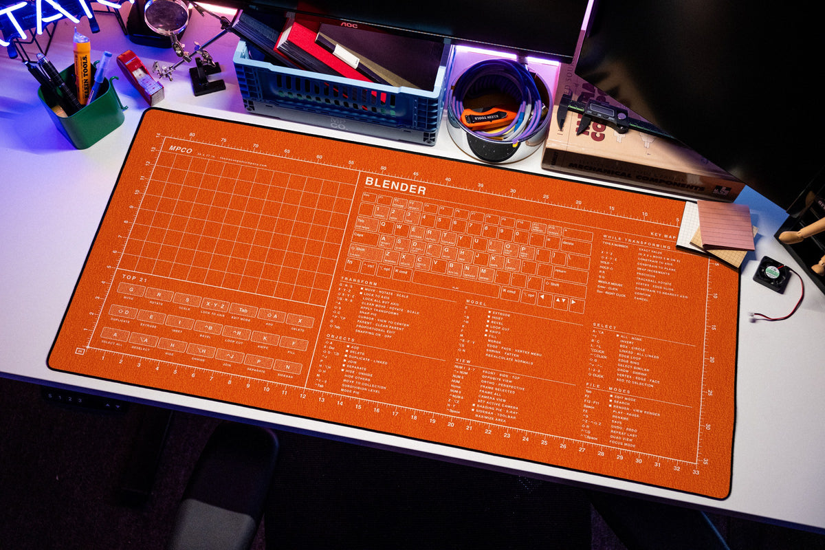 Blender Shortcuts Pad (macOS) desk mat in Orange / White, shown on a styled desk setup