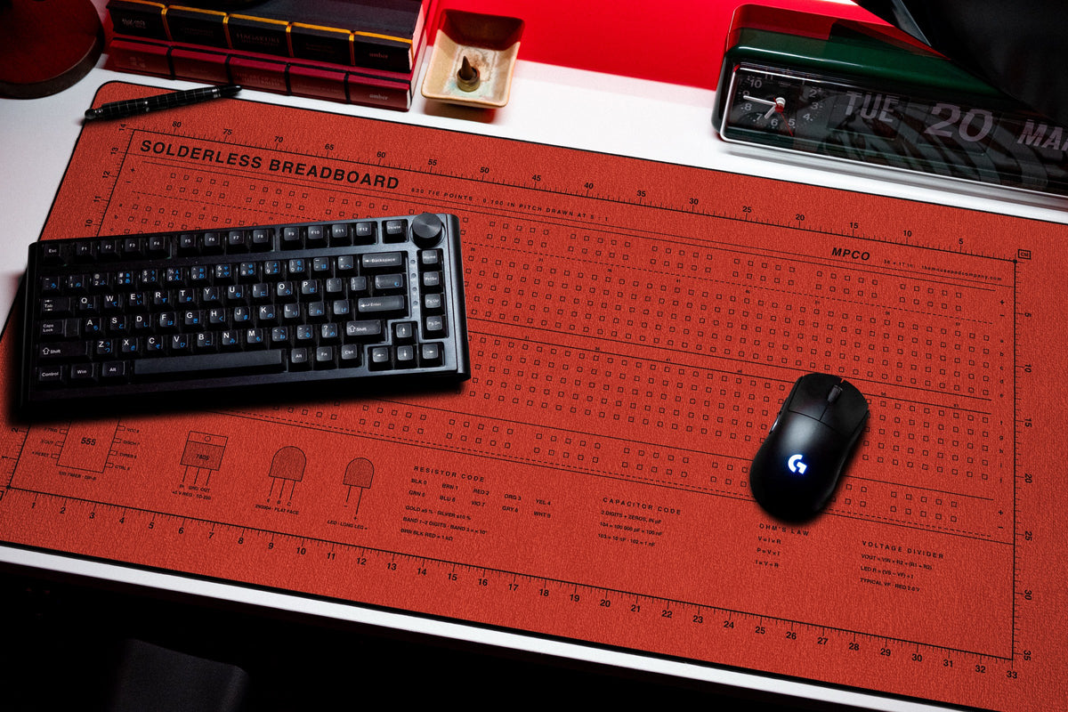 Breadboard Pad desk mat in Red / Black, shown on a styled desk setup