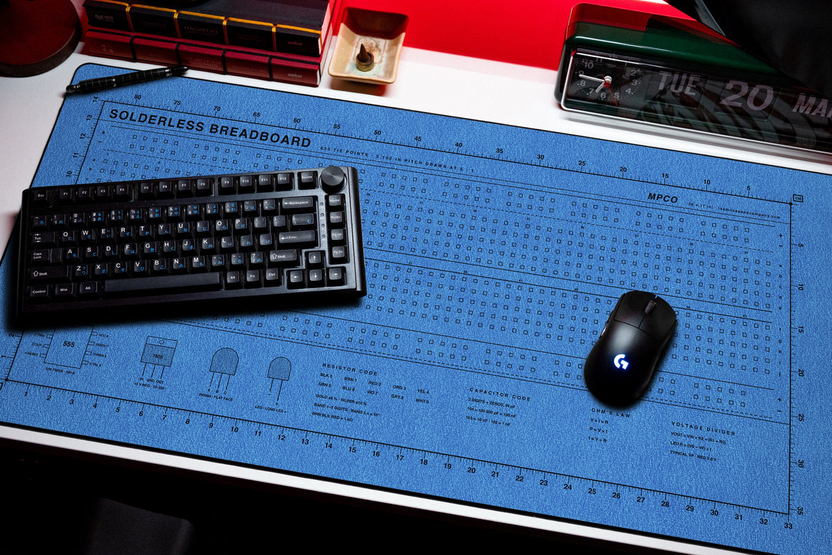 Breadboard Pad desk mat in Swiss Blue, shown on a styled desk setup
