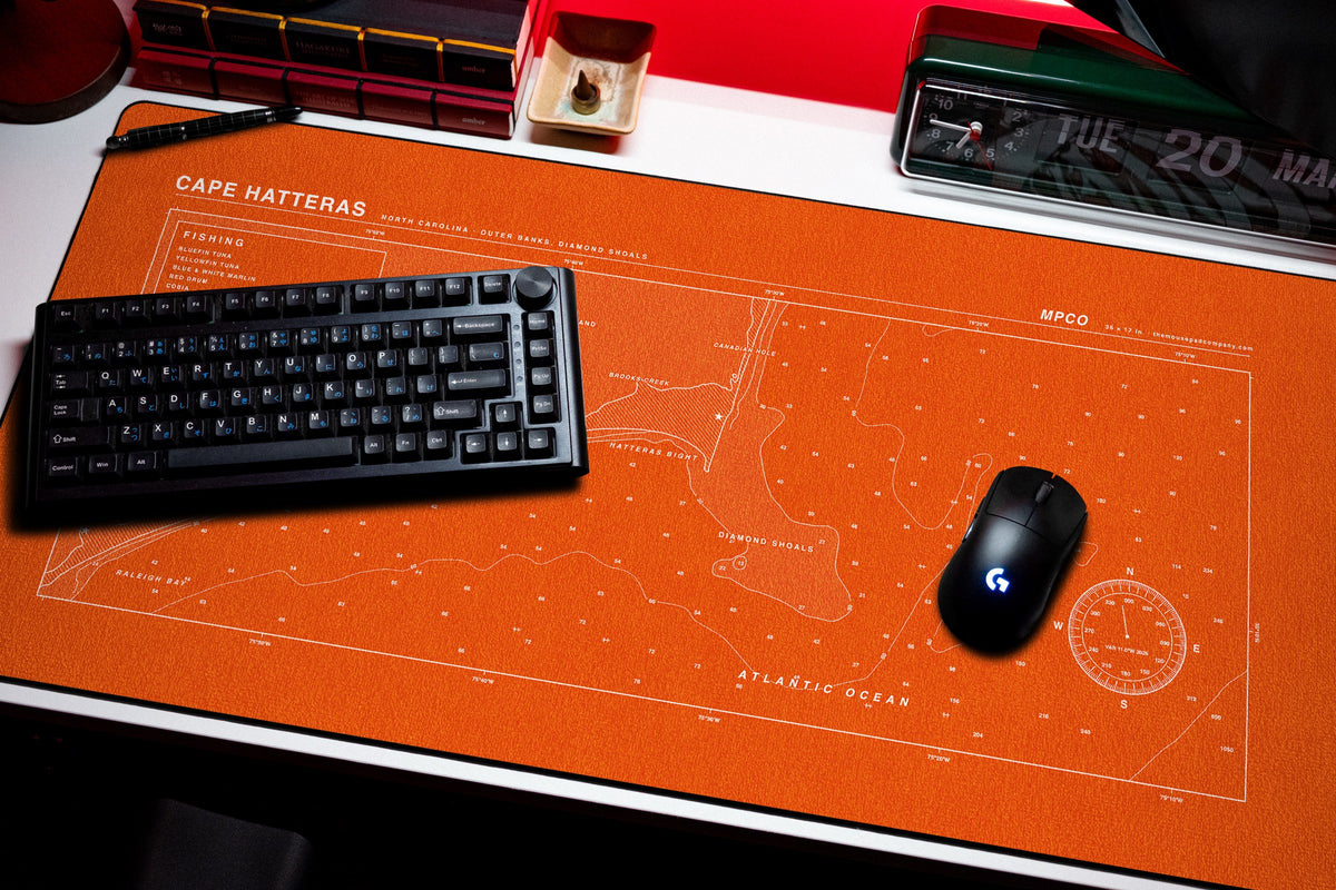 Cape Hatteras Nautical Chart Pad desk mat in Orange / White, shown on a styled desk setup