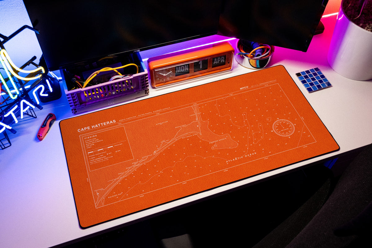 Cape Hatteras Nautical Chart Pad desk mat in Orange / White, shown on a styled desk setup
