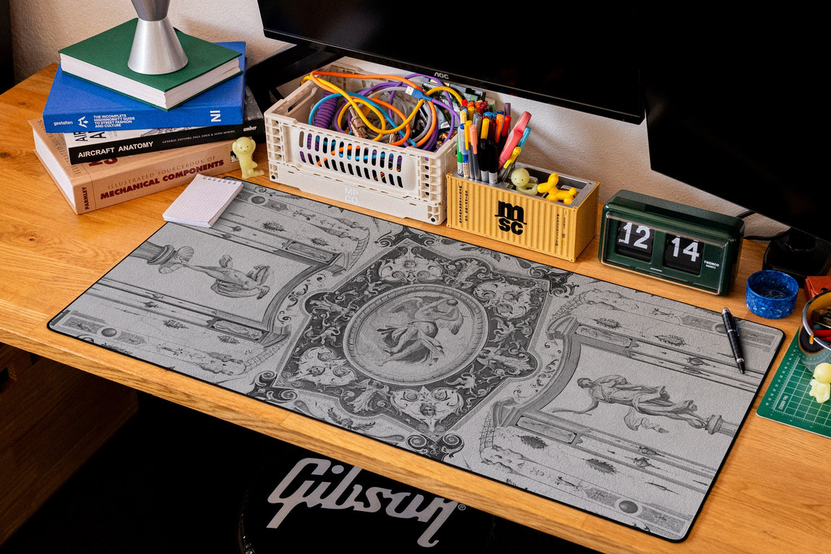 Celestial Messenger desk mat in Dark, shown on a styled desk setup