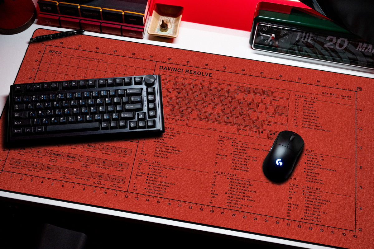 DaVinci Resolve Shortcuts Pad (macOS) desk mat in Red / Black, shown on a styled desk setup
