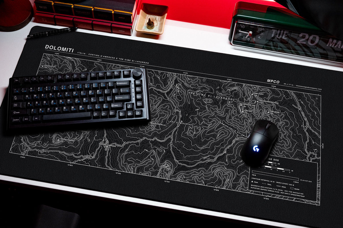 Dolomites Topo Pad desk mat in Black / White, shown on a styled desk setup