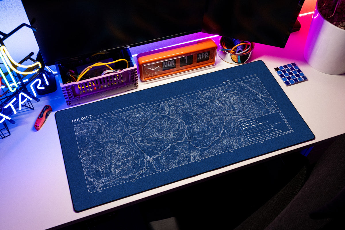 Dolomites Topo Pad desk mat in Blue / White, shown on a styled desk setup