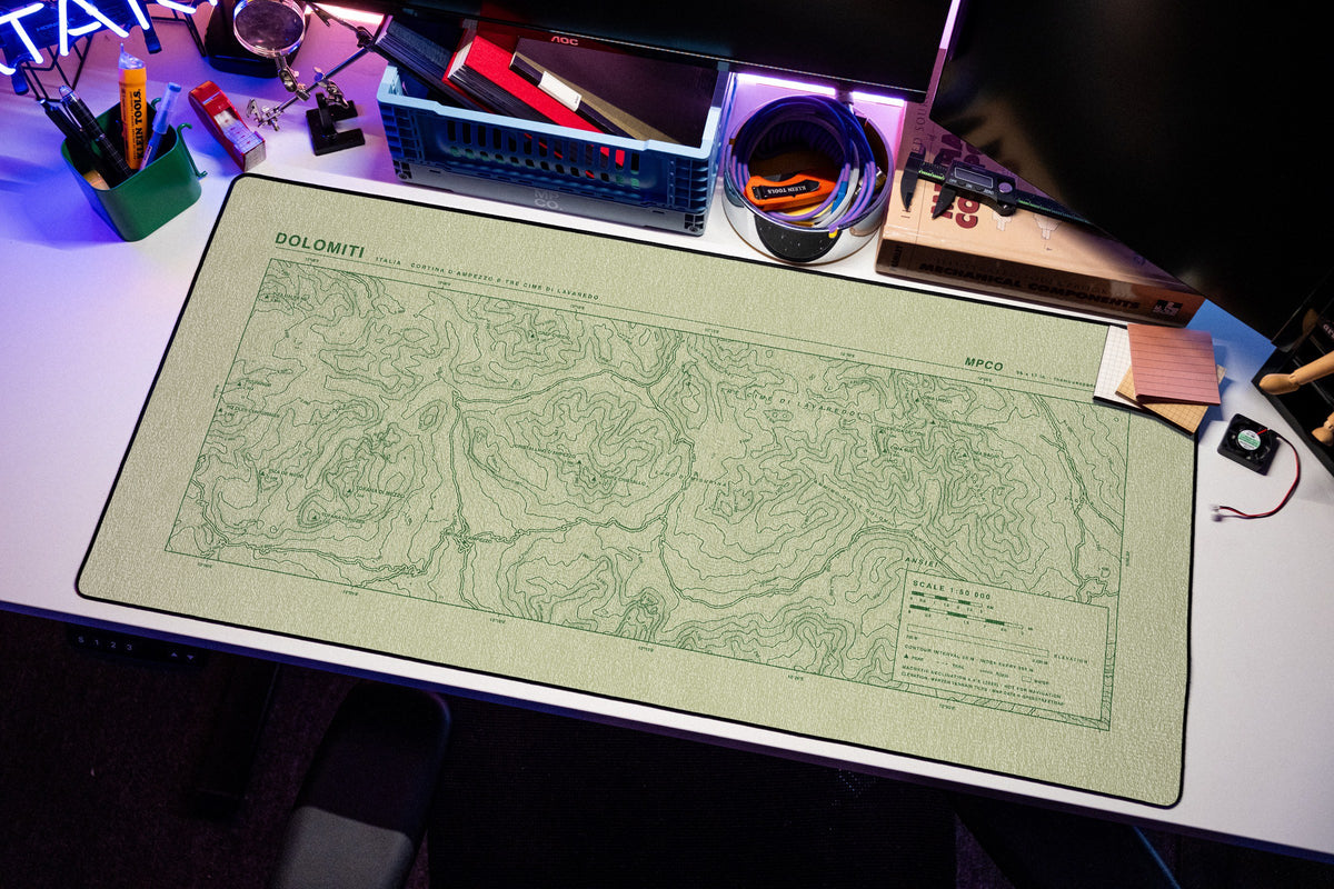 Dolomites Topo Pad desk mat in Buff / Green, shown on a styled desk setup