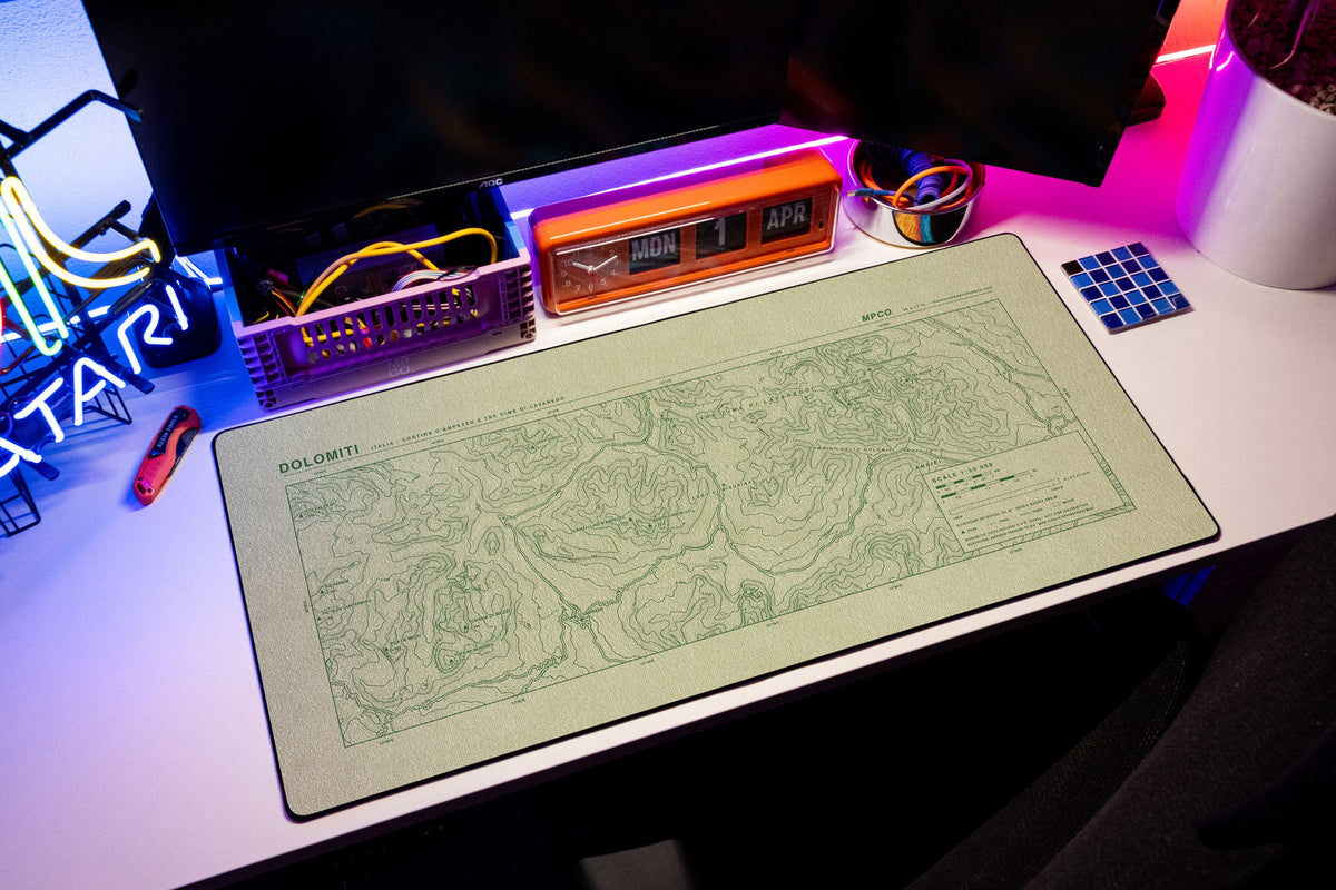 Dolomites Topo Pad desk mat in Buff / Green, shown on a styled desk setup
