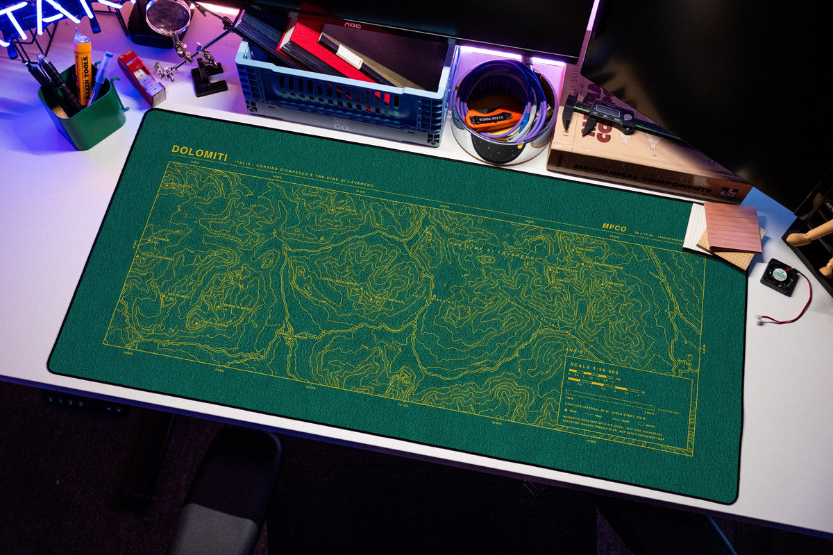 Dolomites Topo Pad desk mat in Green / Yellow, shown on a styled desk setup