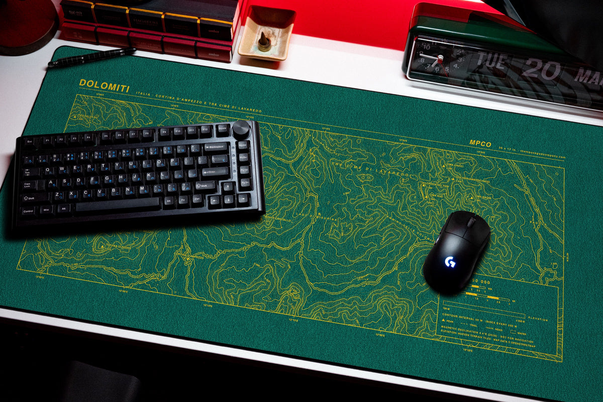 Dolomites Topo Pad desk mat in Green / Yellow, shown on a styled desk setup