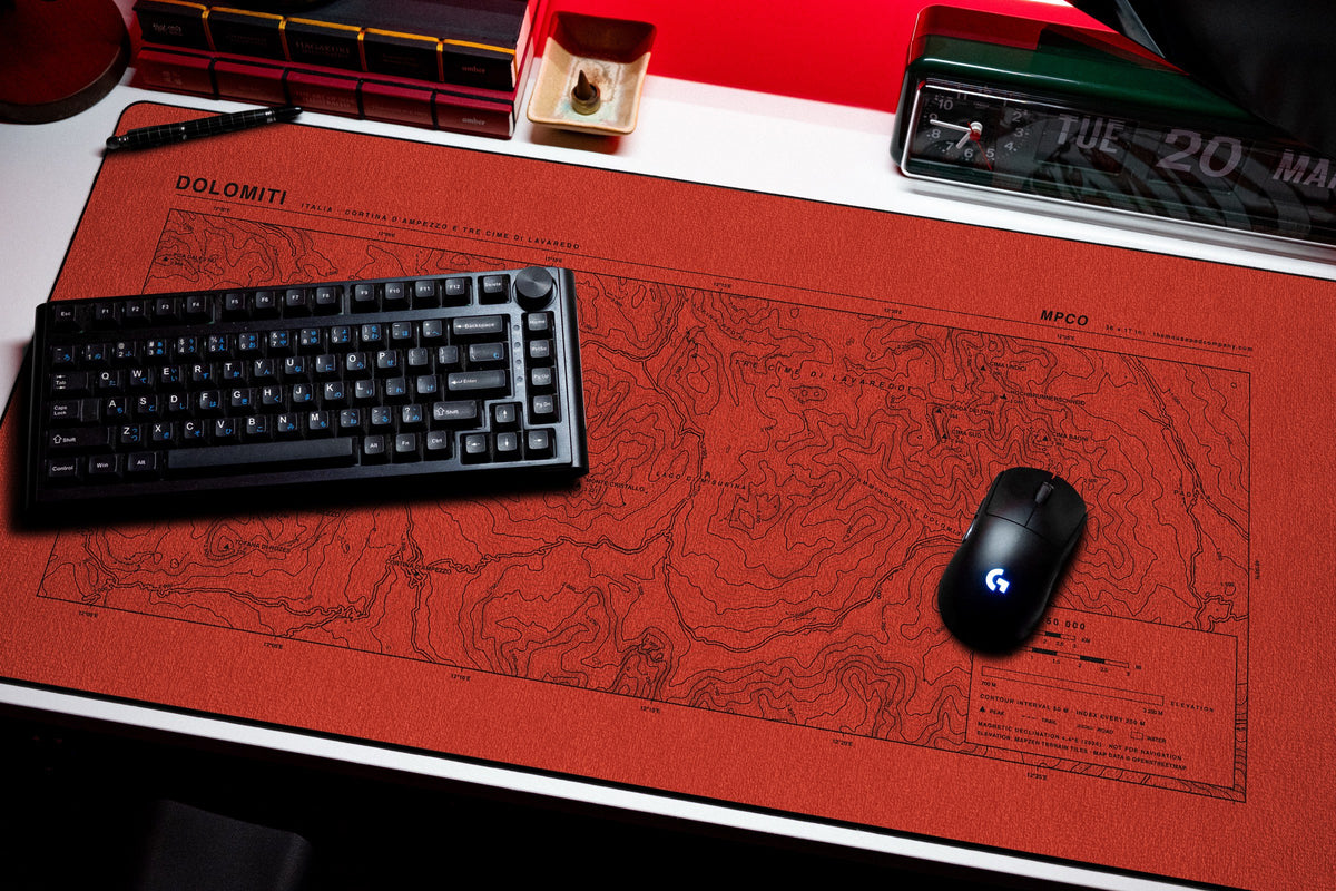 Dolomites Topo Pad desk mat in Red / Black, shown on a styled desk setup