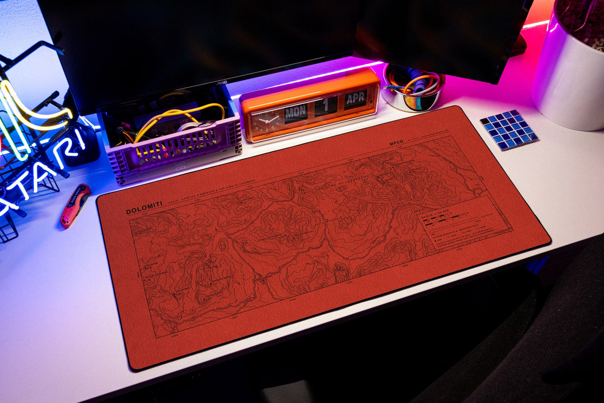Dolomites Topo Pad desk mat in Red / Black, shown on a styled desk setup