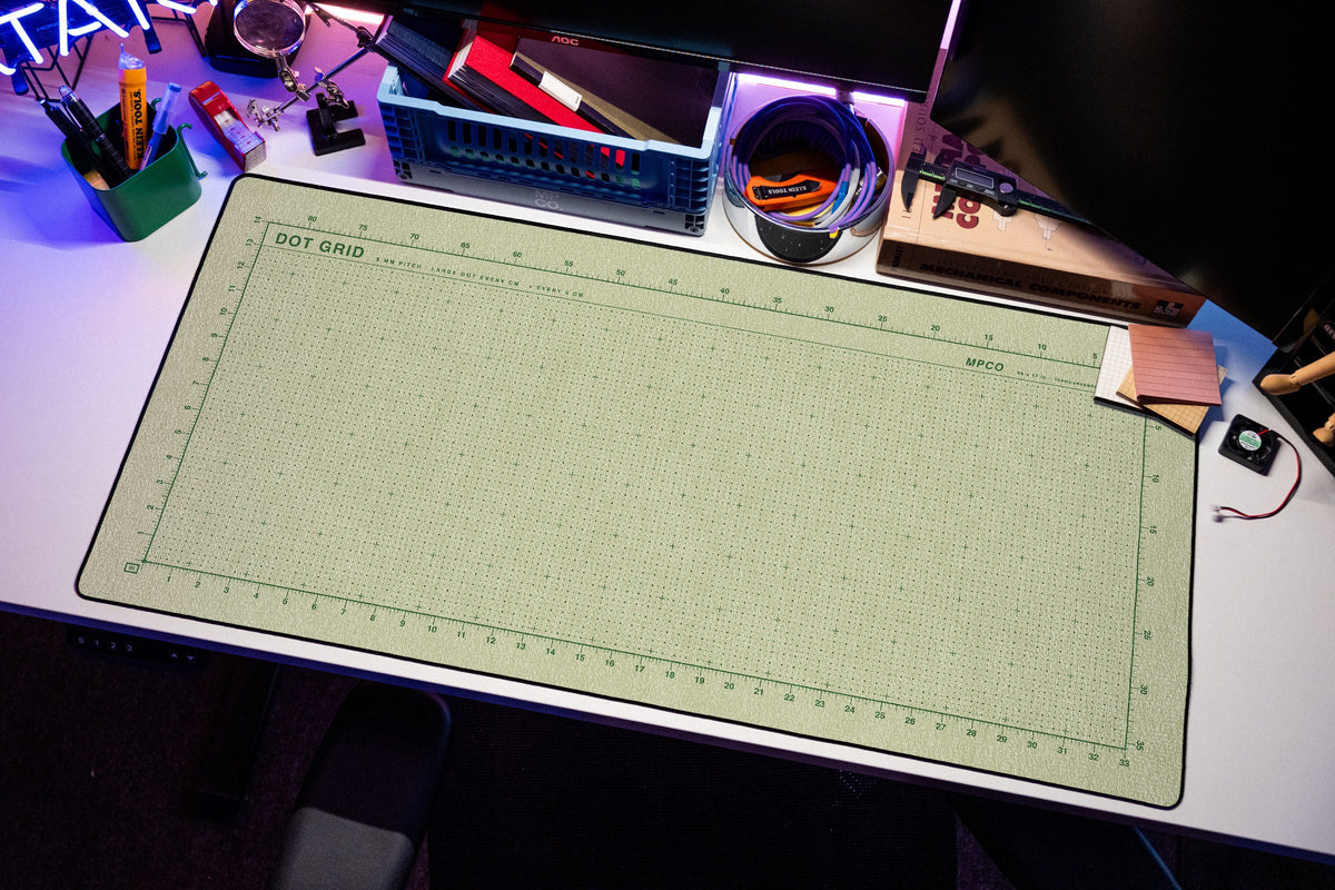 Dot Grid Pad desk mat in Buff / Green, shown on a styled desk setup