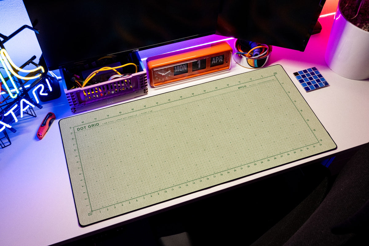 Dot Grid Pad desk mat in Buff / Green, shown on a styled desk setup