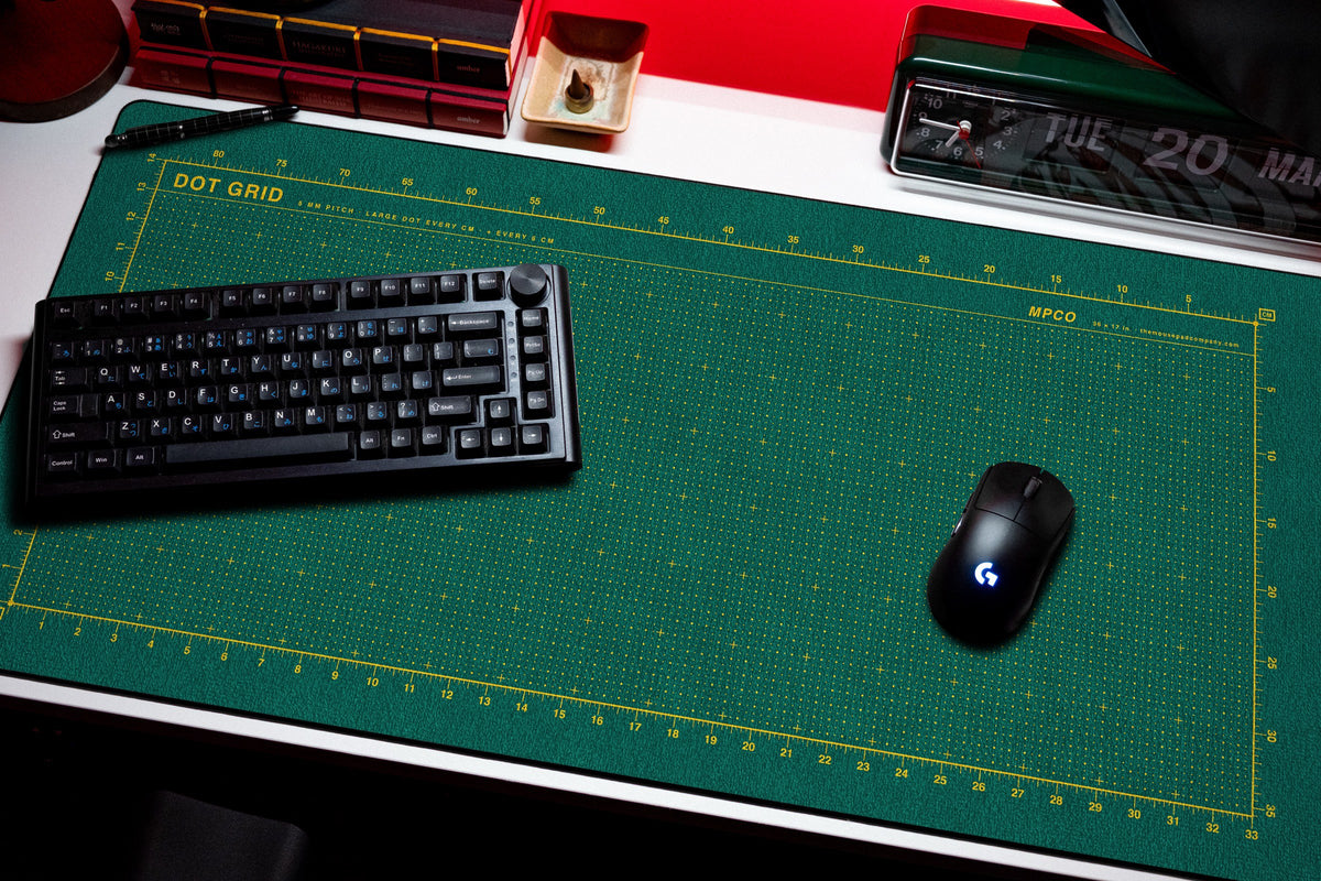 Dot Grid Pad desk mat in Green / Yellow, shown on a styled desk setup