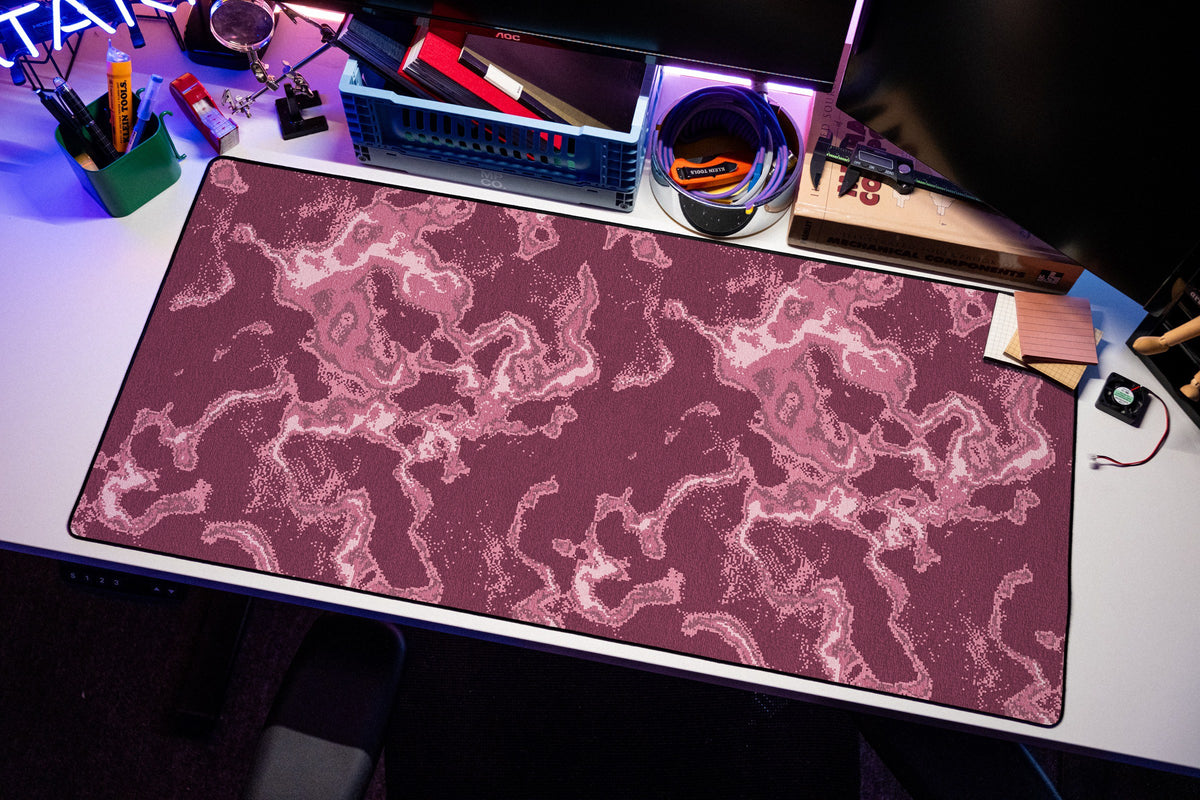 Ember desk mat in Pink, shown on a styled desk setup