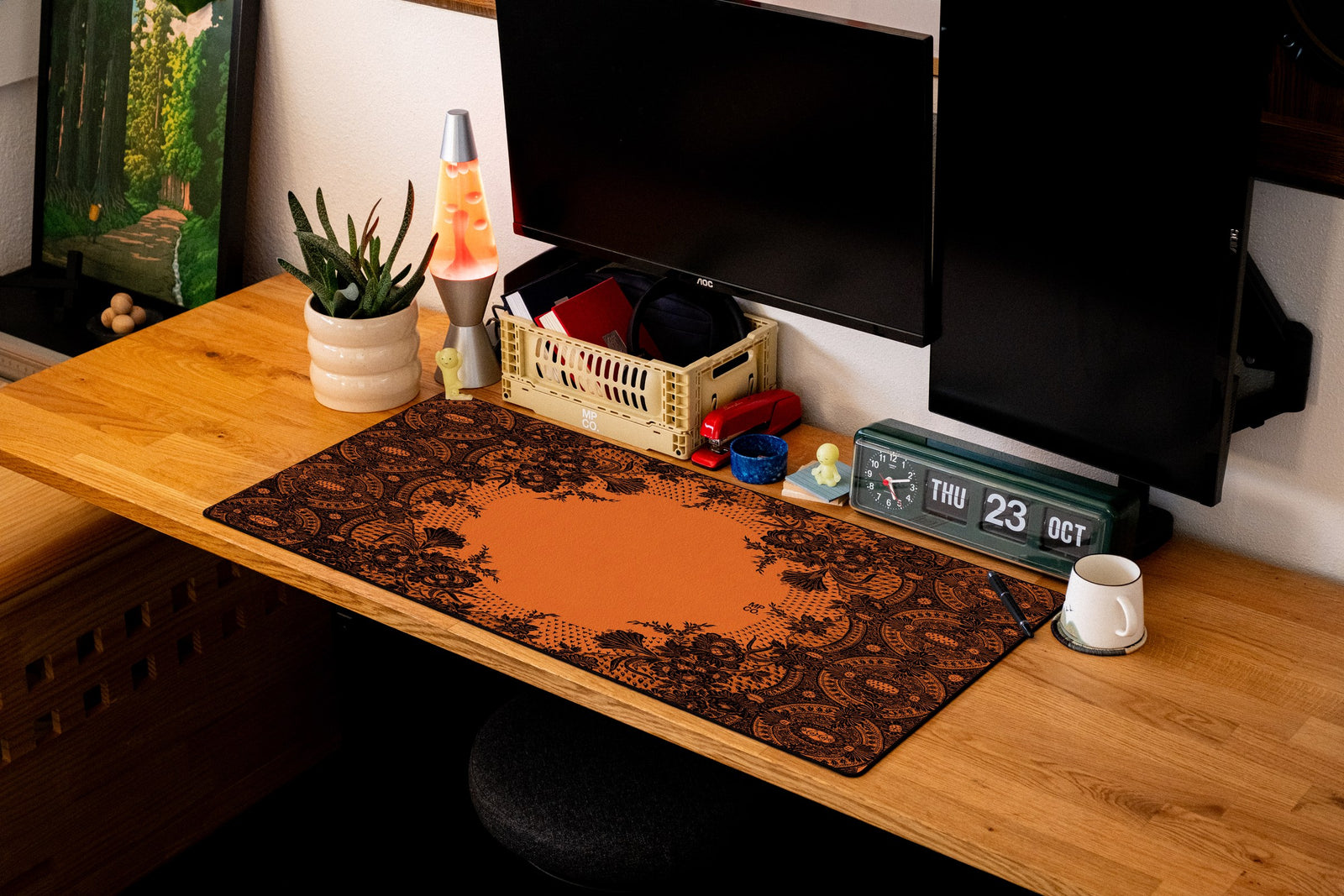 Floral Lace desk mat in Black Lace on Orange, shown on a styled desk setup