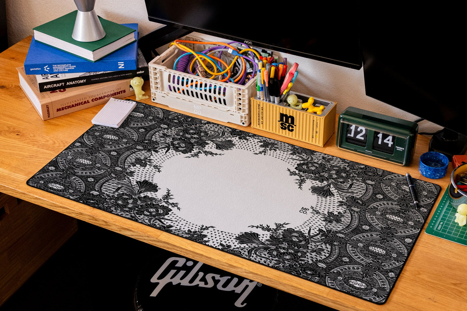 Floral Lace desk mat in Black, shown on a styled desk setup