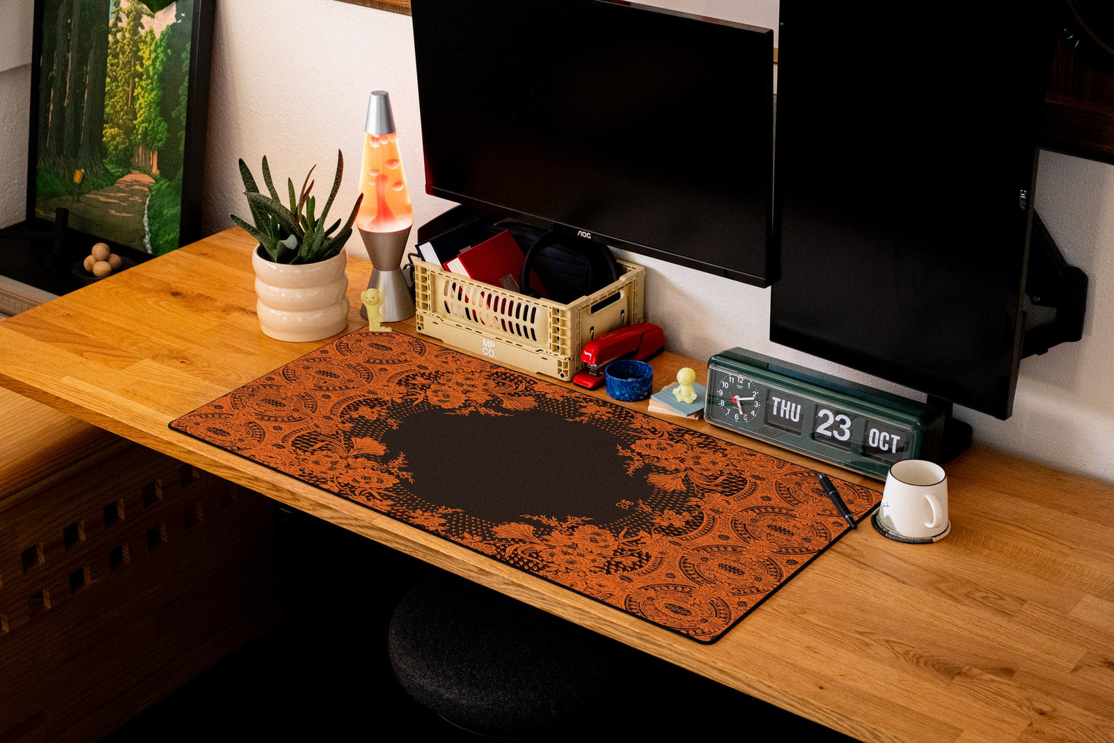 Floral Lace desk mat in Orange Lace on Black, shown on a styled desk setup