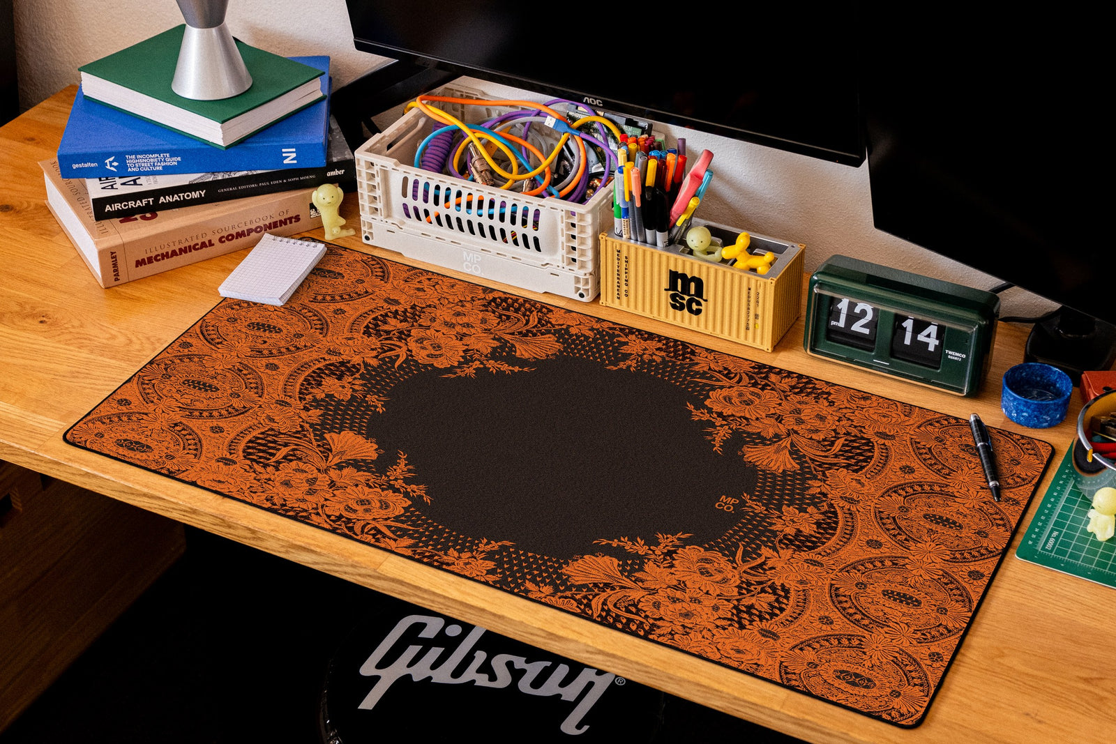 Floral Lace desk mat in Orange Lace on Black, shown on a styled desk setup