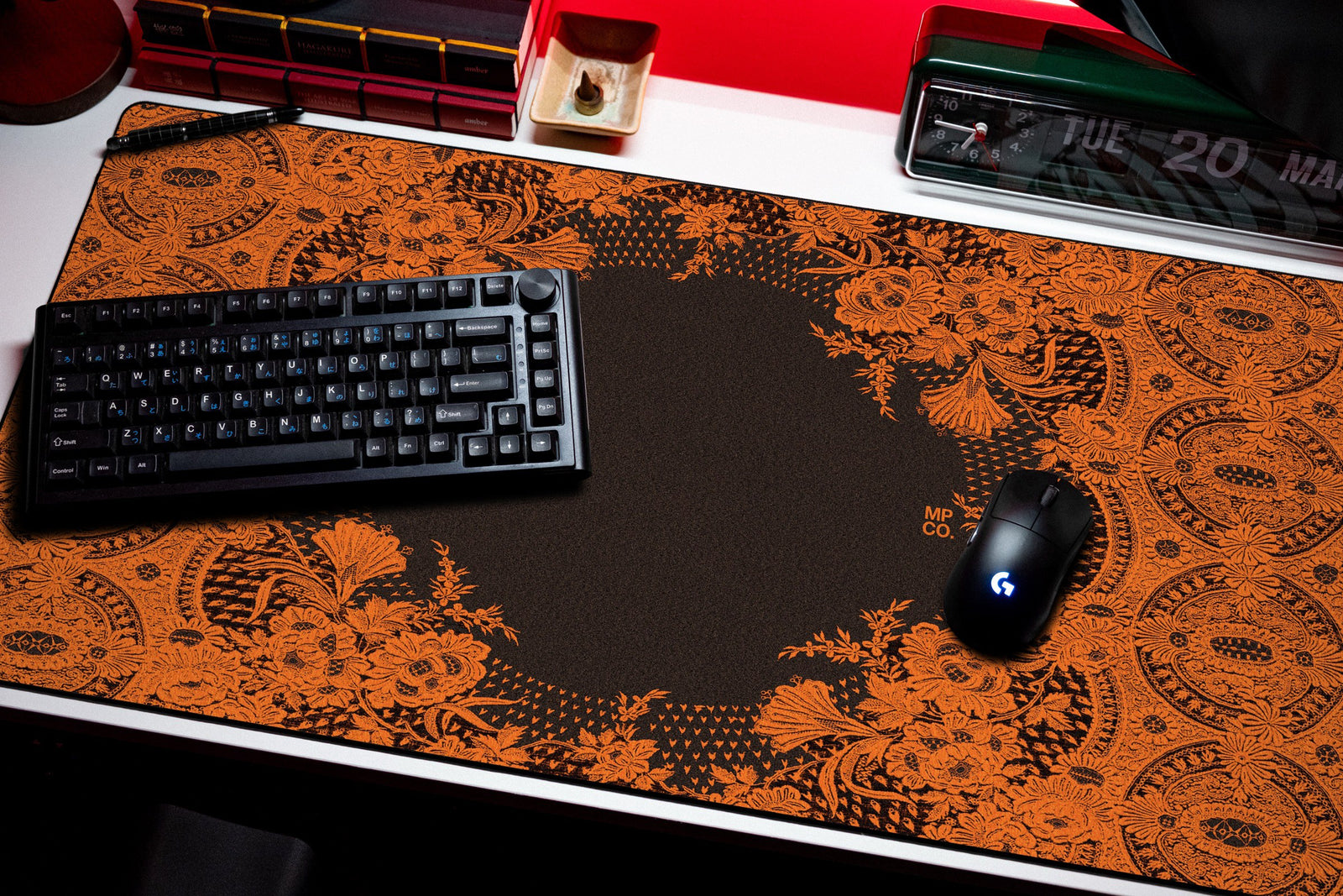 Floral Lace desk mat in Orange Lace on Black, shown on a styled desk setup