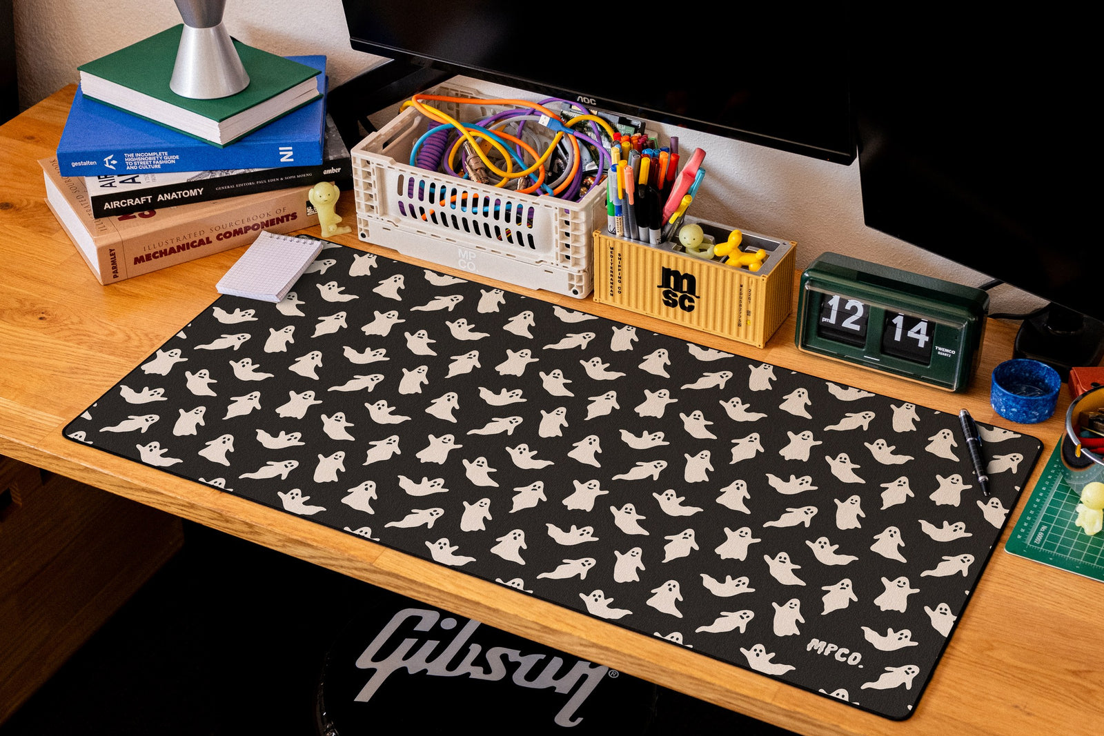 Ghosts desk mat in Black, shown on a styled desk setup