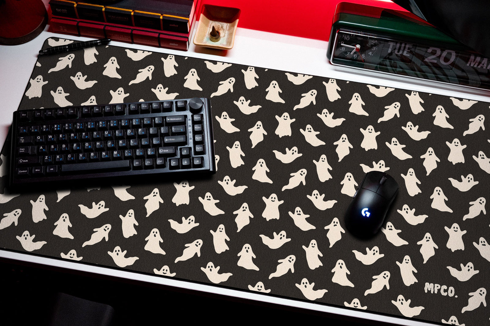 Ghosts desk mat in Black, shown on a styled desk setup