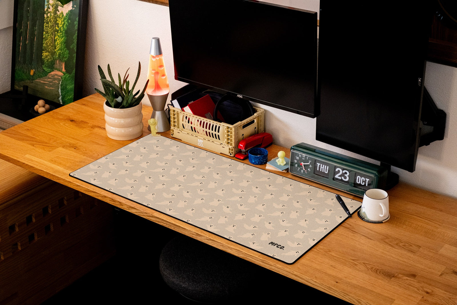 Ghosts desk mat in Cream, shown on a styled desk setup