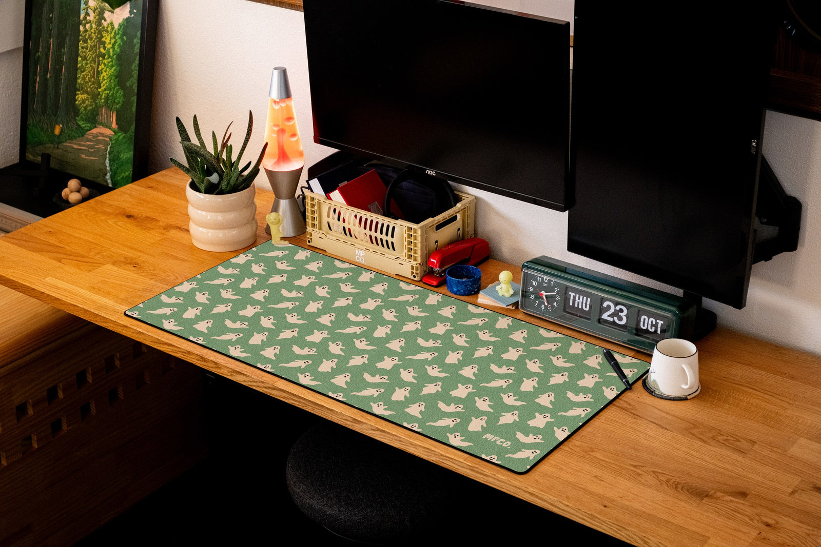 Ghosts desk mat in Green, shown on a styled desk setup